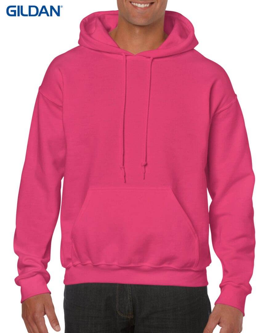 A man wearing a pink hoodie with a black background