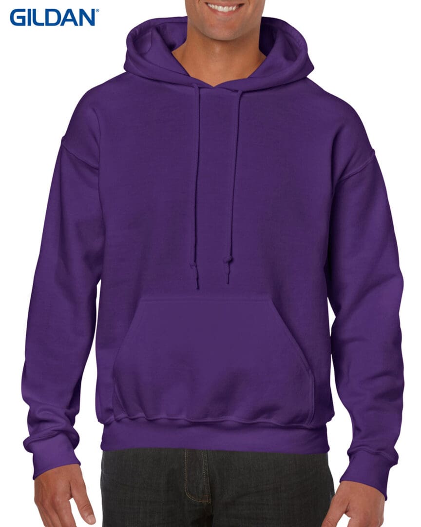 A man wearing a purple hoodie with his hands in the pocket.