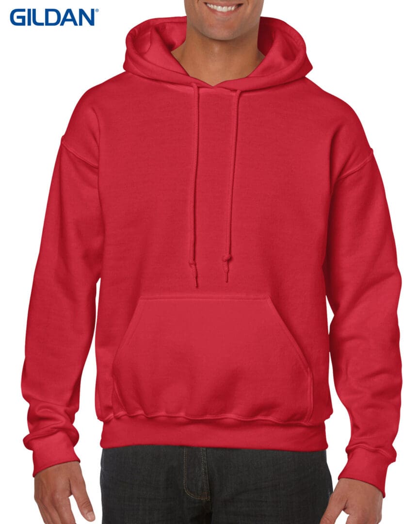 A man wearing a red hoodie with his hands on the hood.