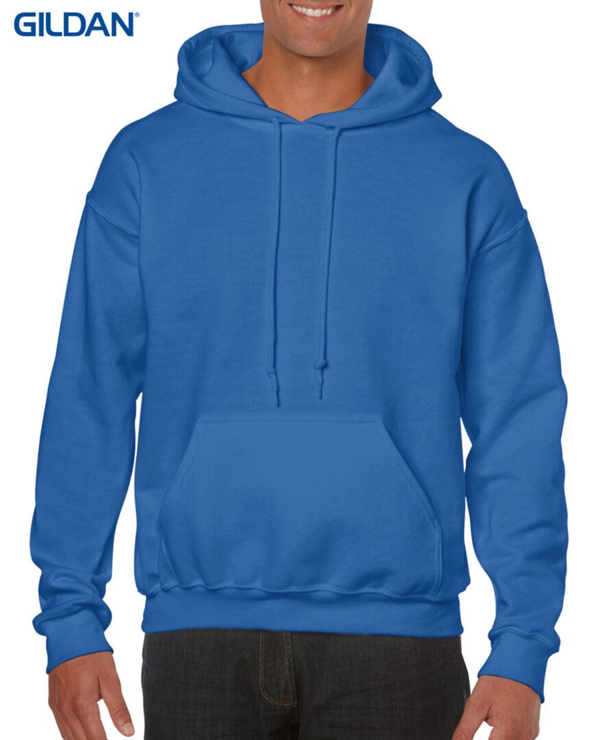 A man wearing a blue hoodie with his hands on the hood.