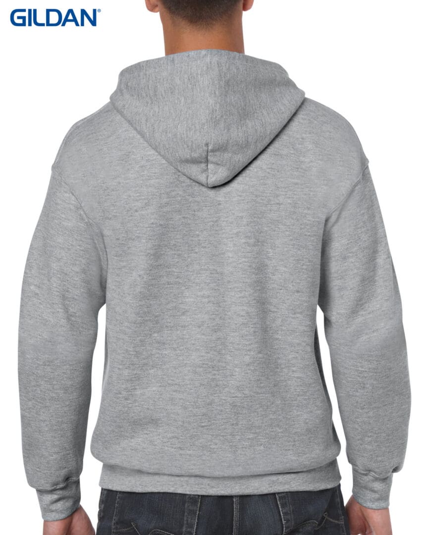 A person wearing a gray hoodie with a white and black design on it.