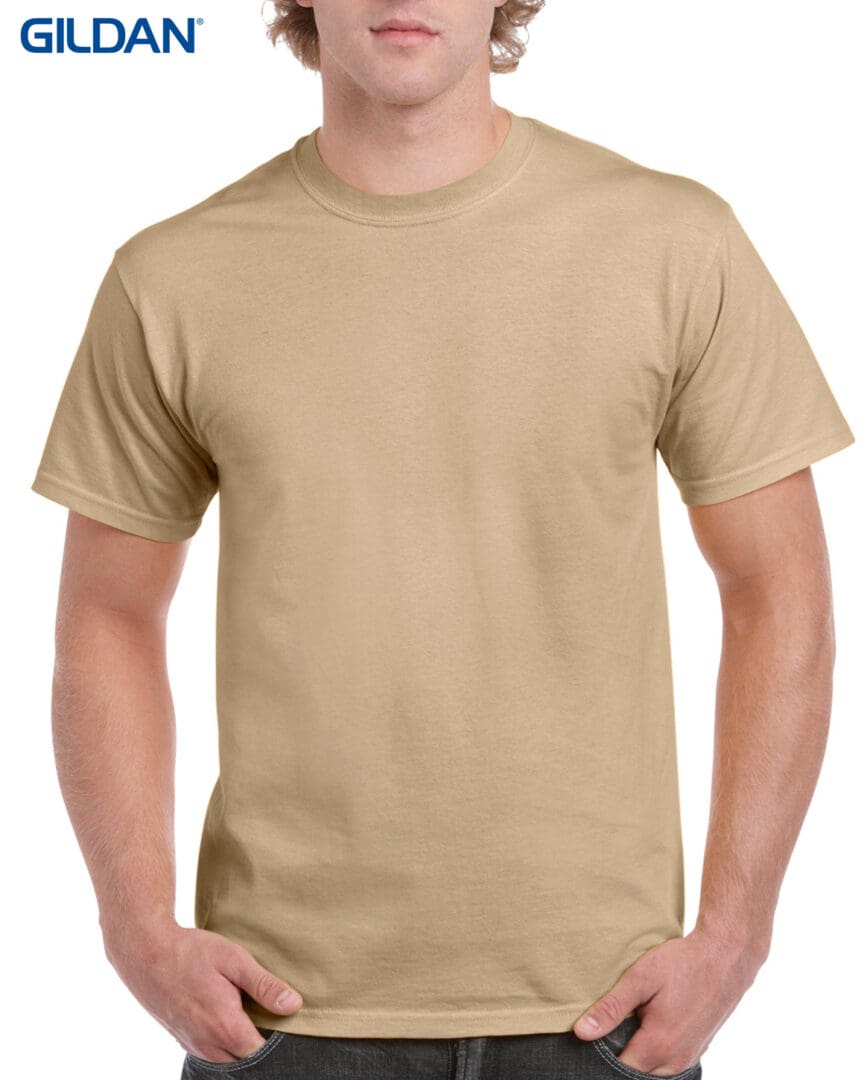 A man wearing a tan t-shirt with no background.