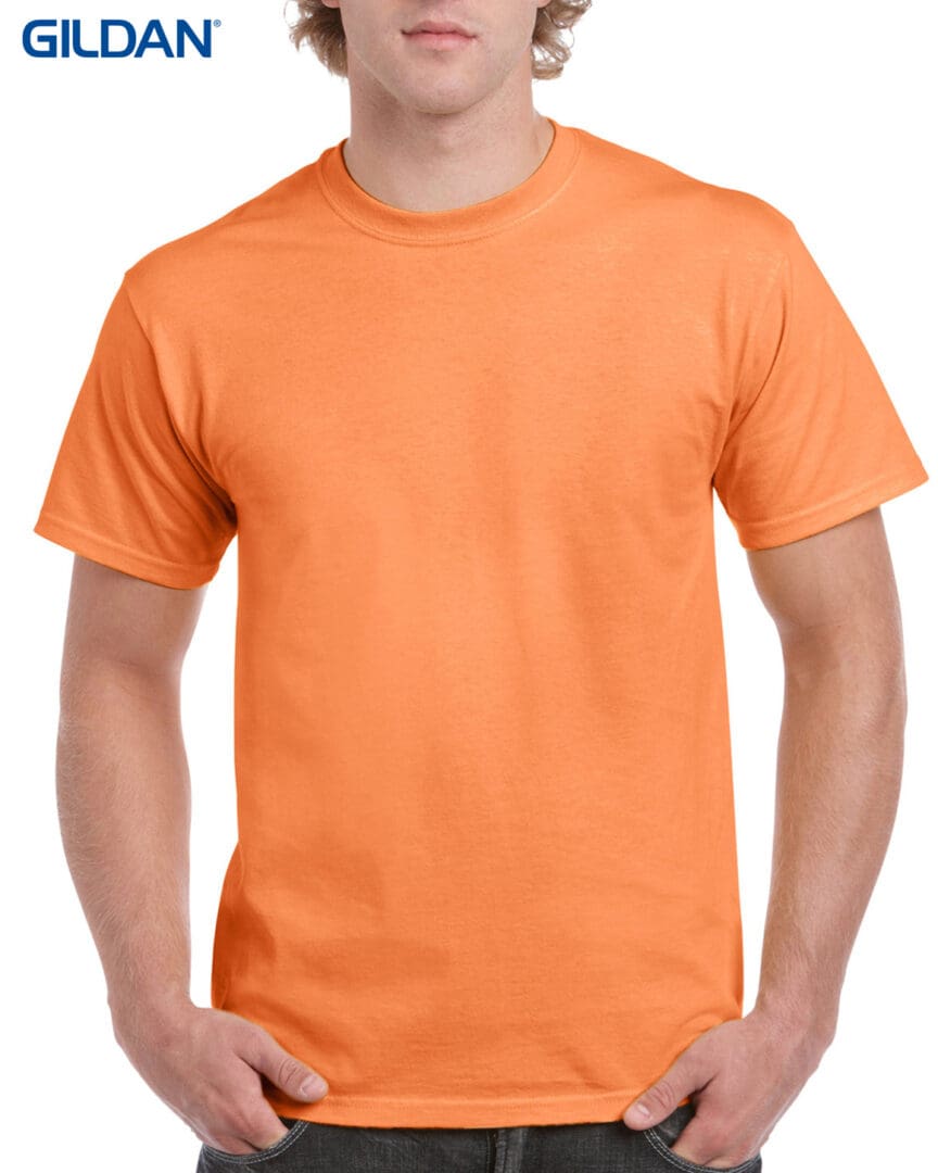 A man wearing an orange t-shirt with no background.