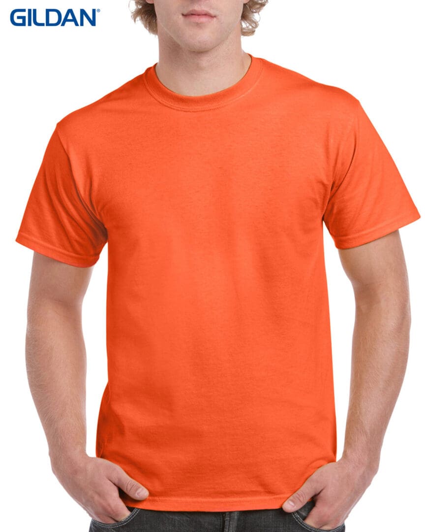 A man wearing an orange t-shirt with no background.