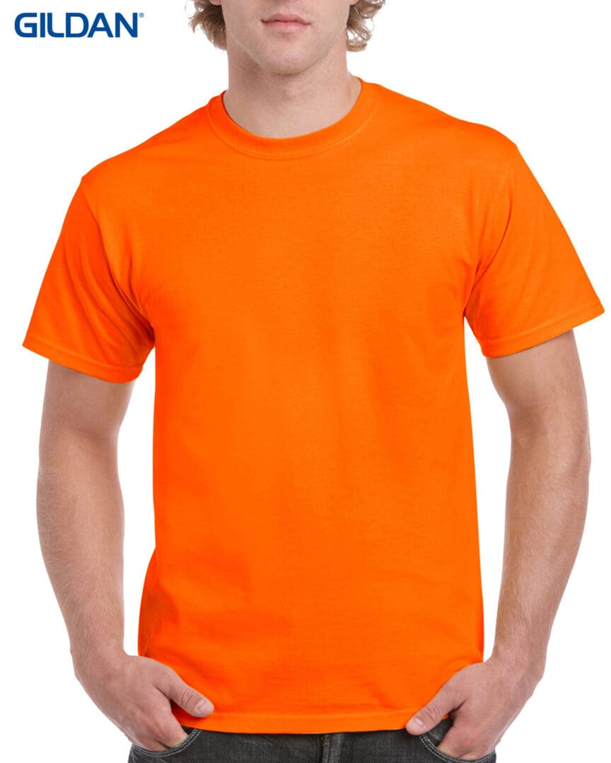 A man wearing an orange shirt and standing next to another man.