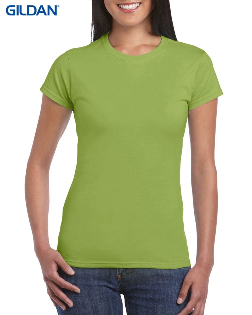 A woman wearing a green shirt and jeans.