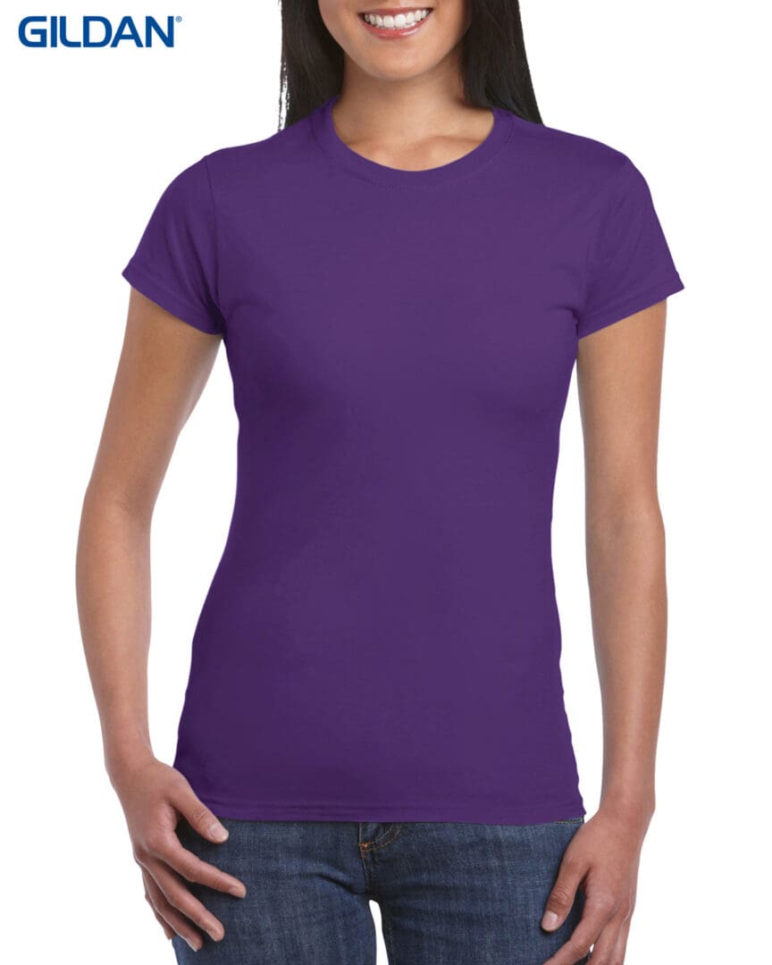 A woman wearing purple shirt and jeans.