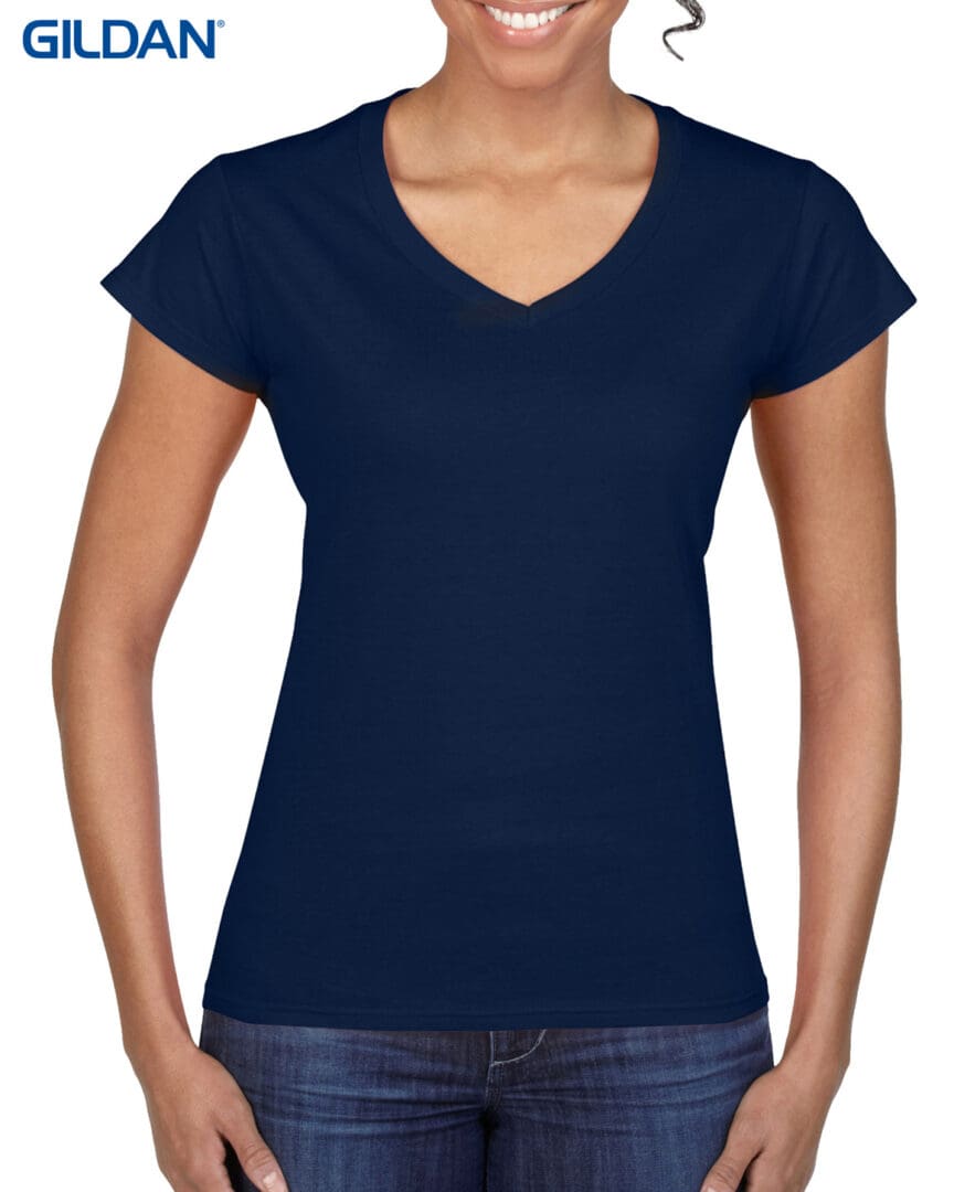 A woman wearing a navy blue shirt and jeans.