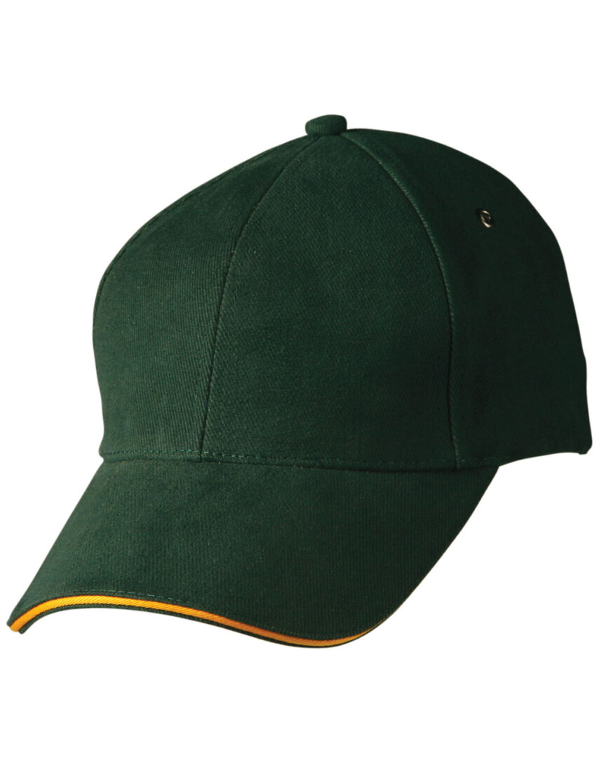 A green hat with yellow trim on top of it.