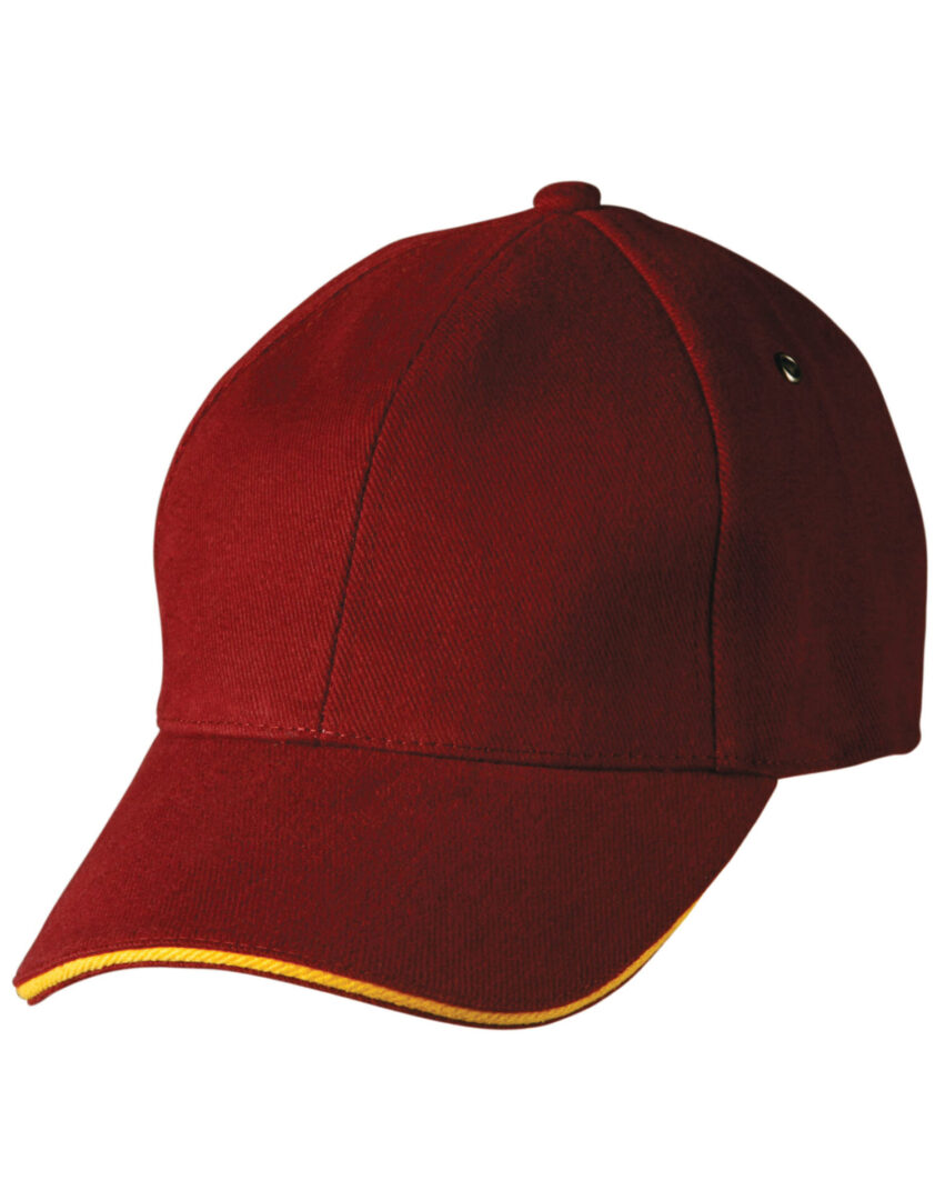 A red hat with yellow trim on top of it.